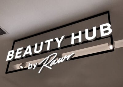 Next beauty hub illuminated block acrylic letters on frame