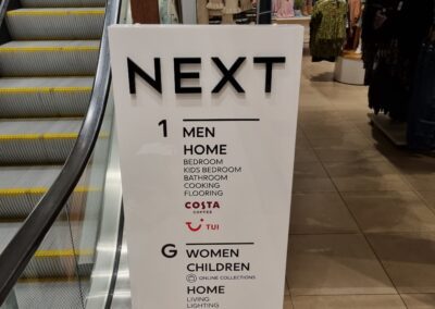 Next store directory totem sign next to escalator