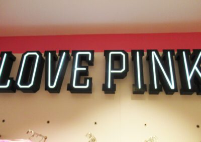 Illuminated Love Pink letters on wall inside Victoria's Secret Store